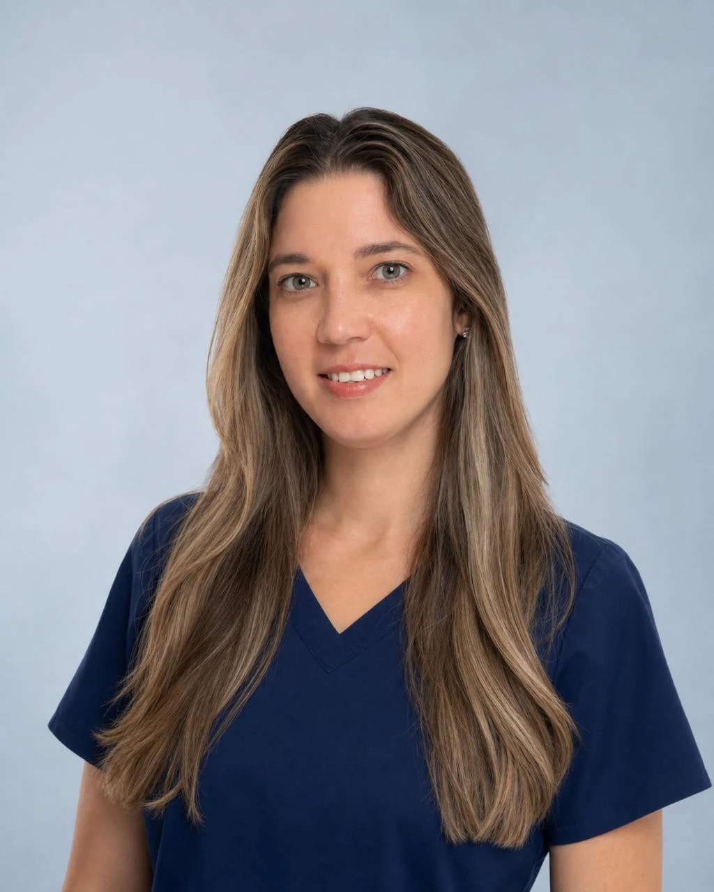 Temporary AI-assisted portrait of Yarelis Lopez, Office Manager at the Miami clinic, wearing navy scrubs against a light background.
